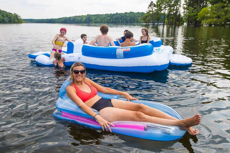 woman in a blue floatie floating on the lake