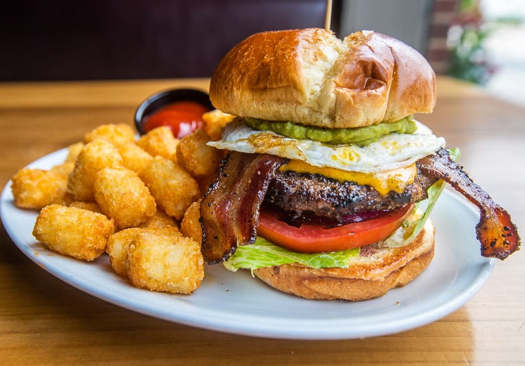 A burger with a side of tater tots