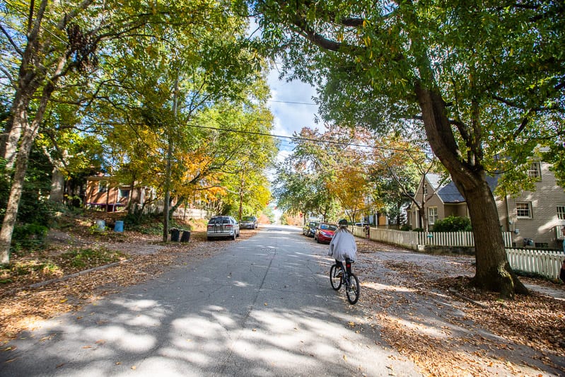 person riding a bike through a neighborhood