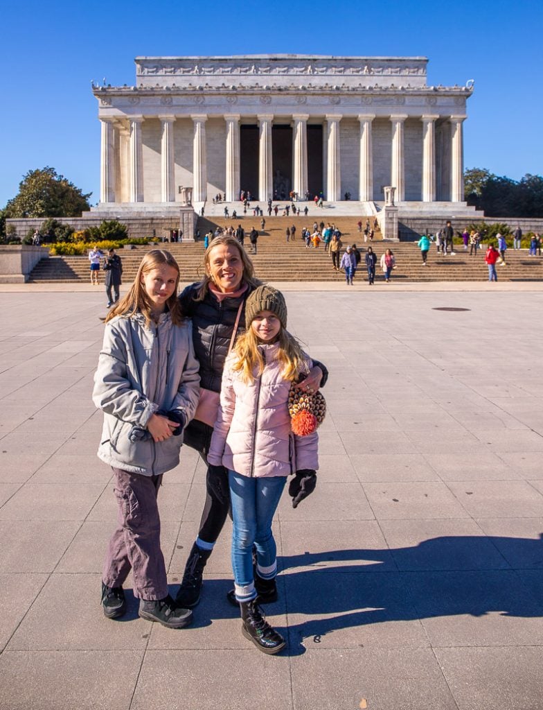family posing in front of Washington DC monument