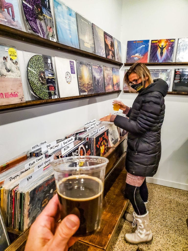woman looking through vinyls in a record store