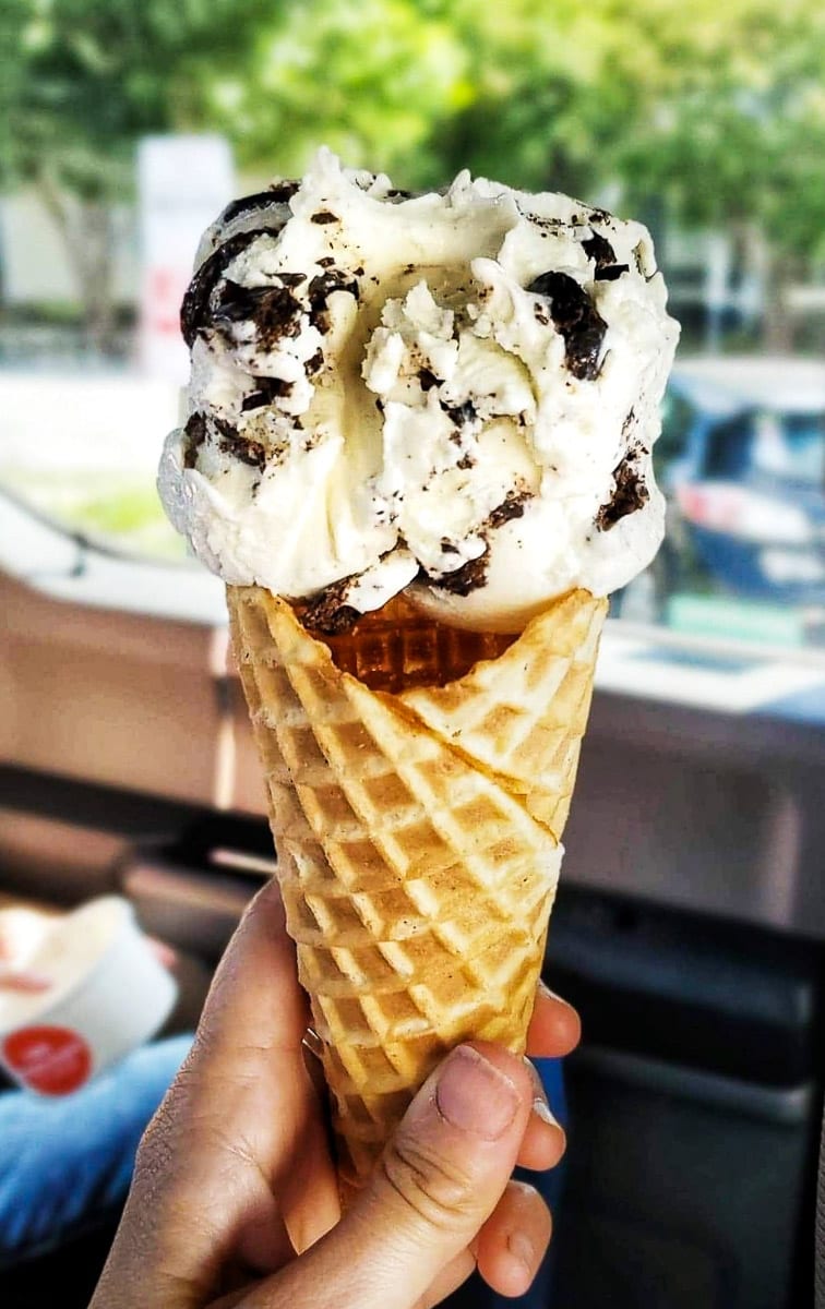 large scoop of chocolate chip ice cream in a waffle cone