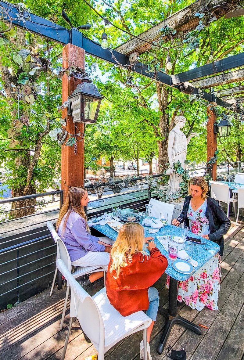 family at table on patio of Taverna Agora Greek Kitchen & Bar