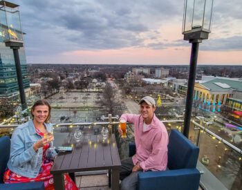 people sitting at a rooftop bar