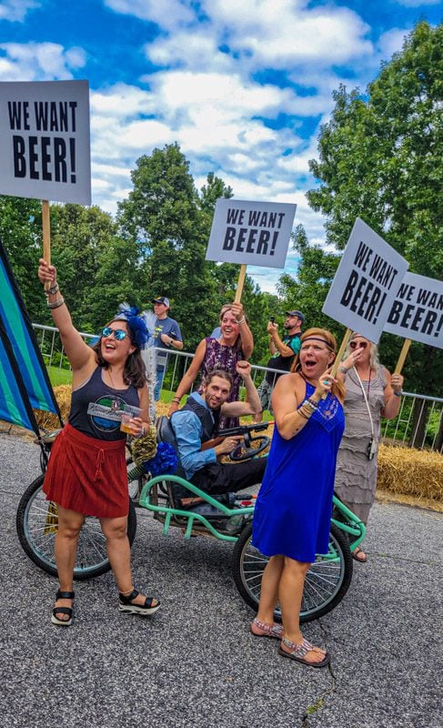 women holding more beer signs