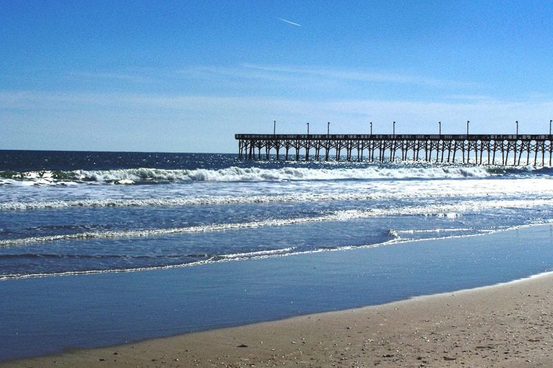 waves next to the pier at Surf City, North Carolina
