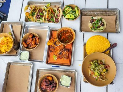 a table filled with different types of mexican food on a plate, cartaco raleigh