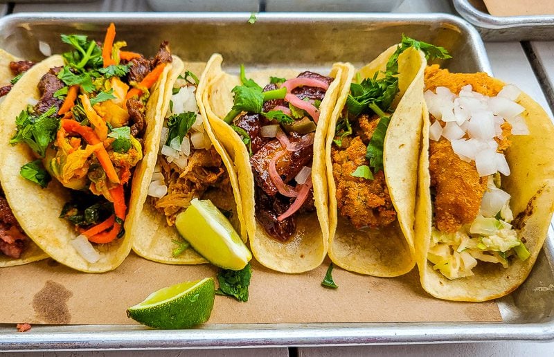 A box filled with different types of tacos