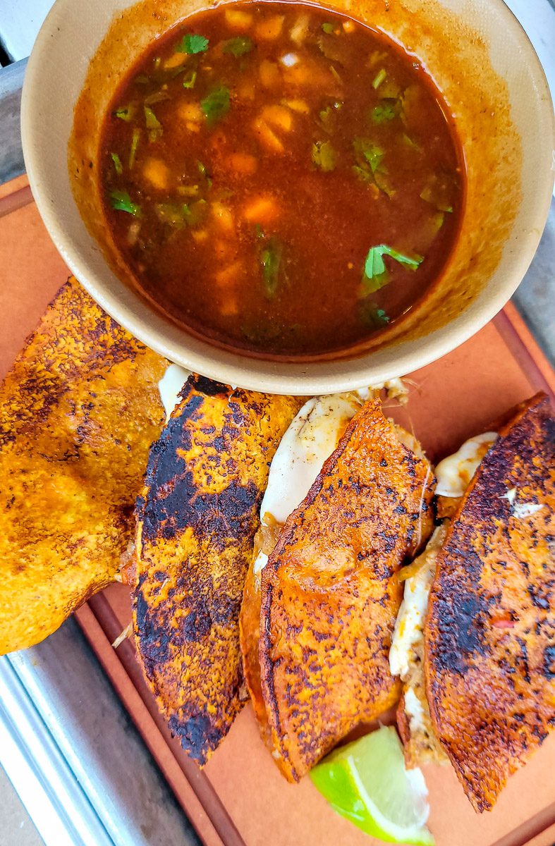 A bowl of soup, with tacos