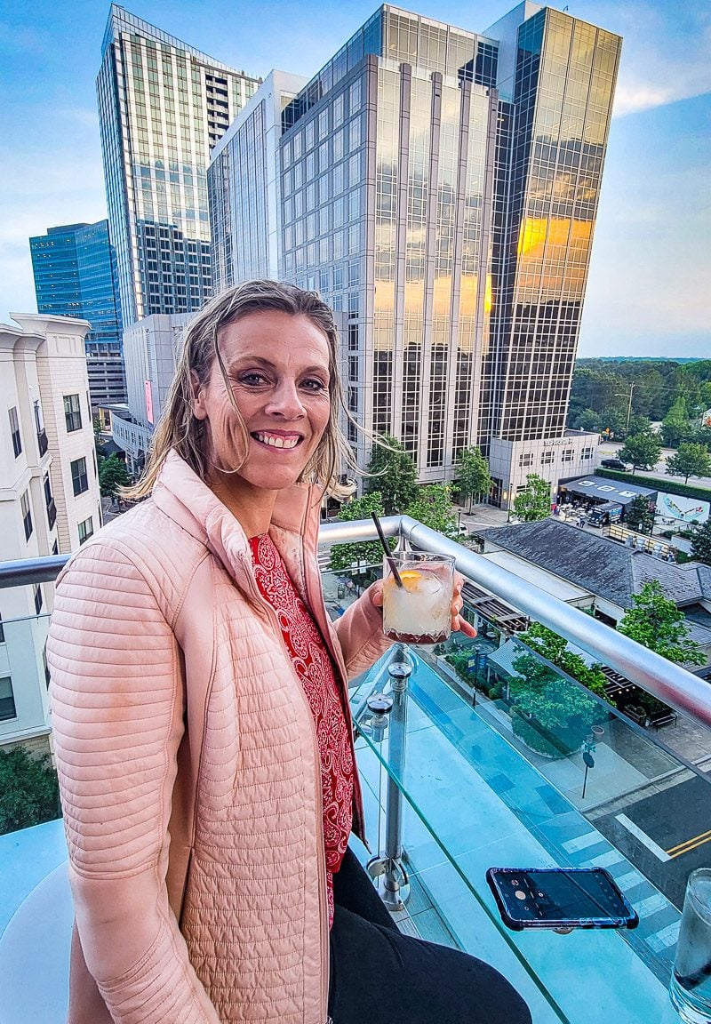 Caroline Makepeace sitting on the rooftop bar of level 7 north hills