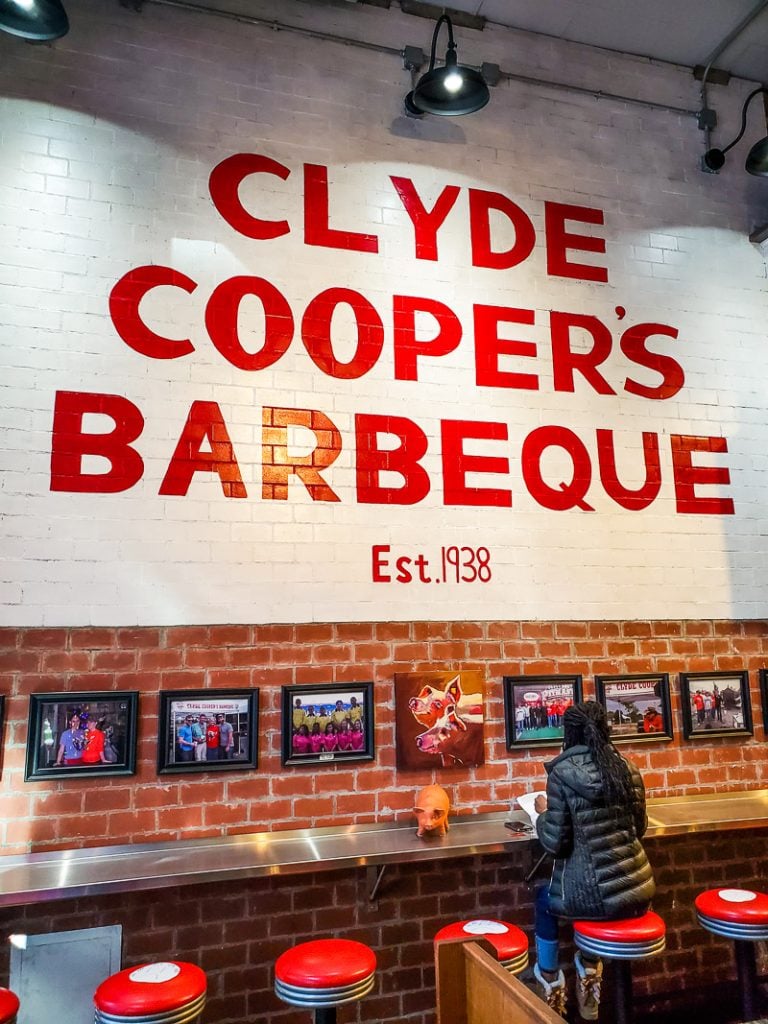 Person sitting inside the Clyde Cooper's BBQ joint
