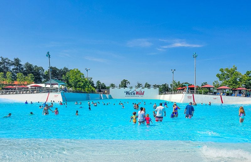 A group of people swimming in a wave pool wet\'n wild