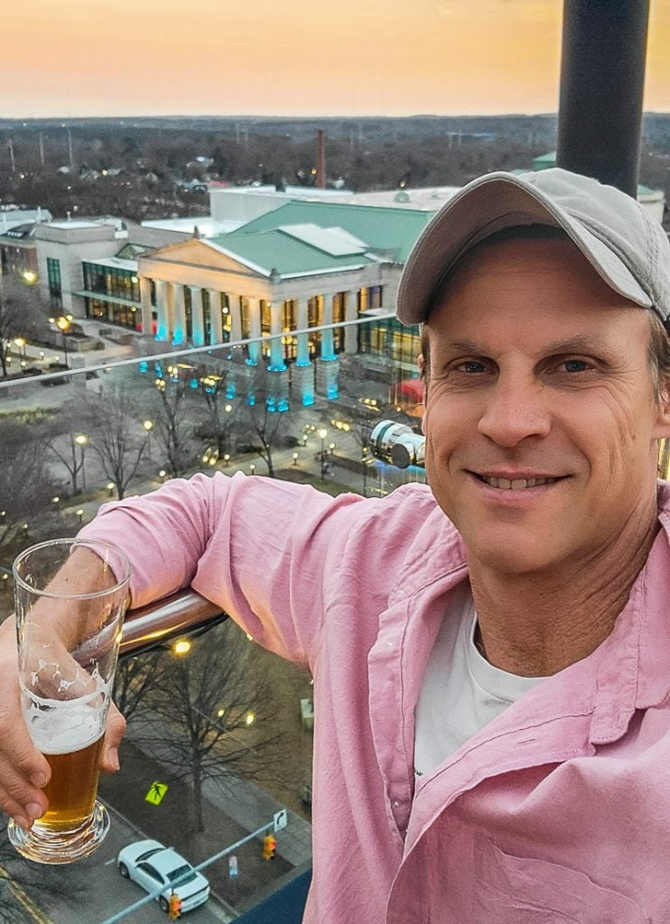 Man enjoying a drink on a rooftop bar