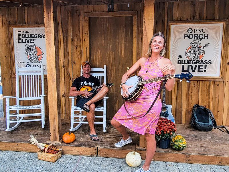 Lady and man playing a banjo and bluegrass instruments