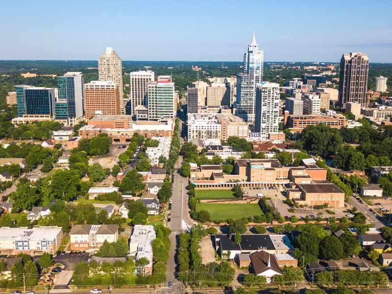 Aerial view of a downtown city buildings, houses, and trees in downtown Raleigh, North Carolina