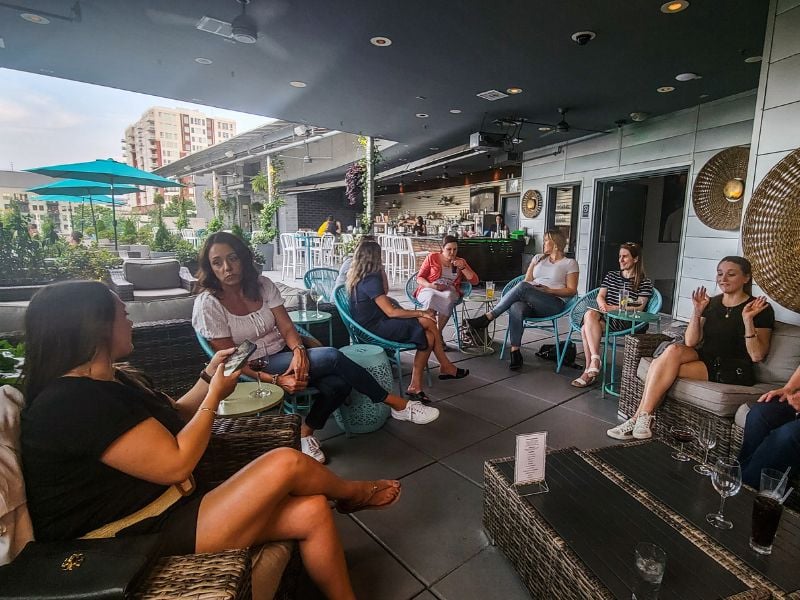 Ladies socializing over drinks on a rooftop bar