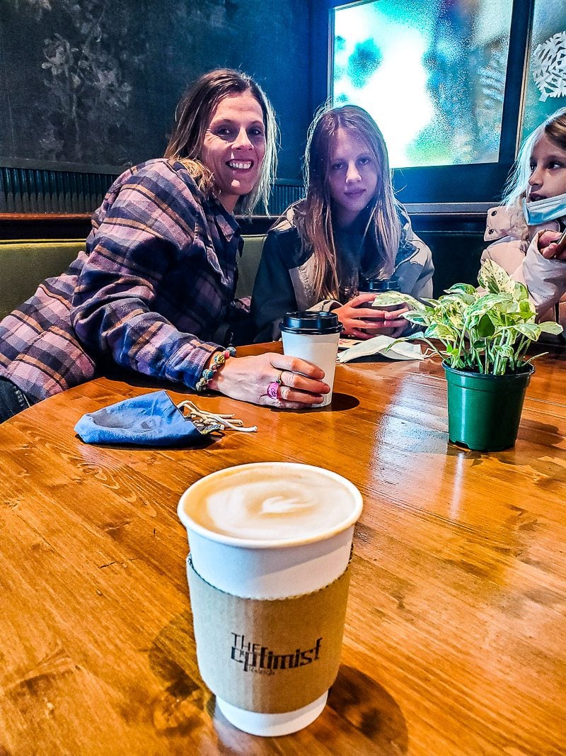 Mother and daughters having a photo taken at a coffee shop