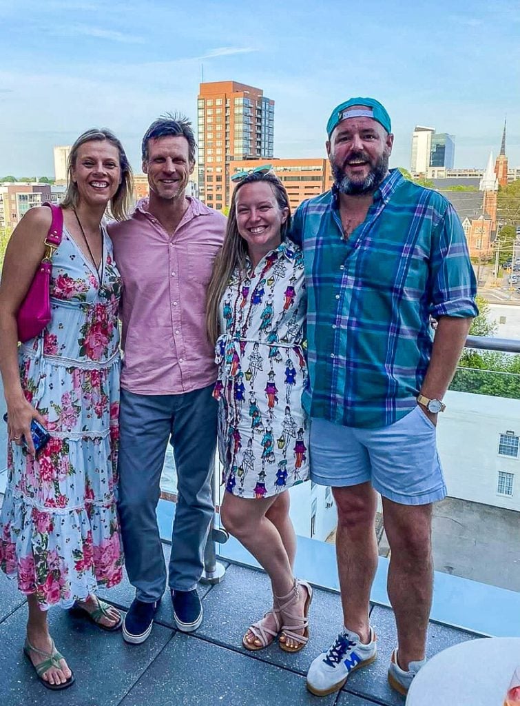 Friends posing for a photo on a rooftop bar