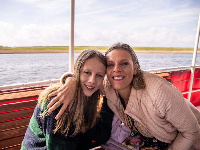 Mother and daughter enjoying a river cruise