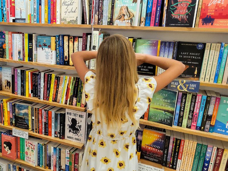 Girl looking at books inside a bookstore