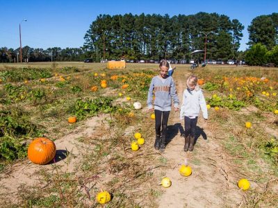 Two girls exploring a pumpkin patch near Raleigh, NC