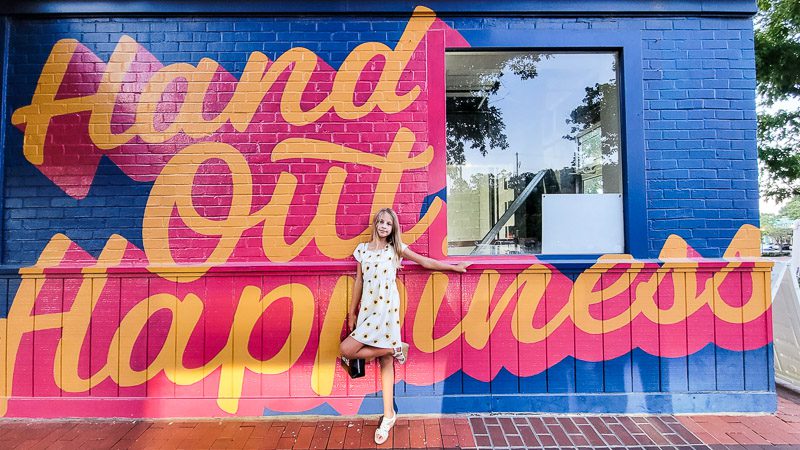 Girl posing in front of a mural