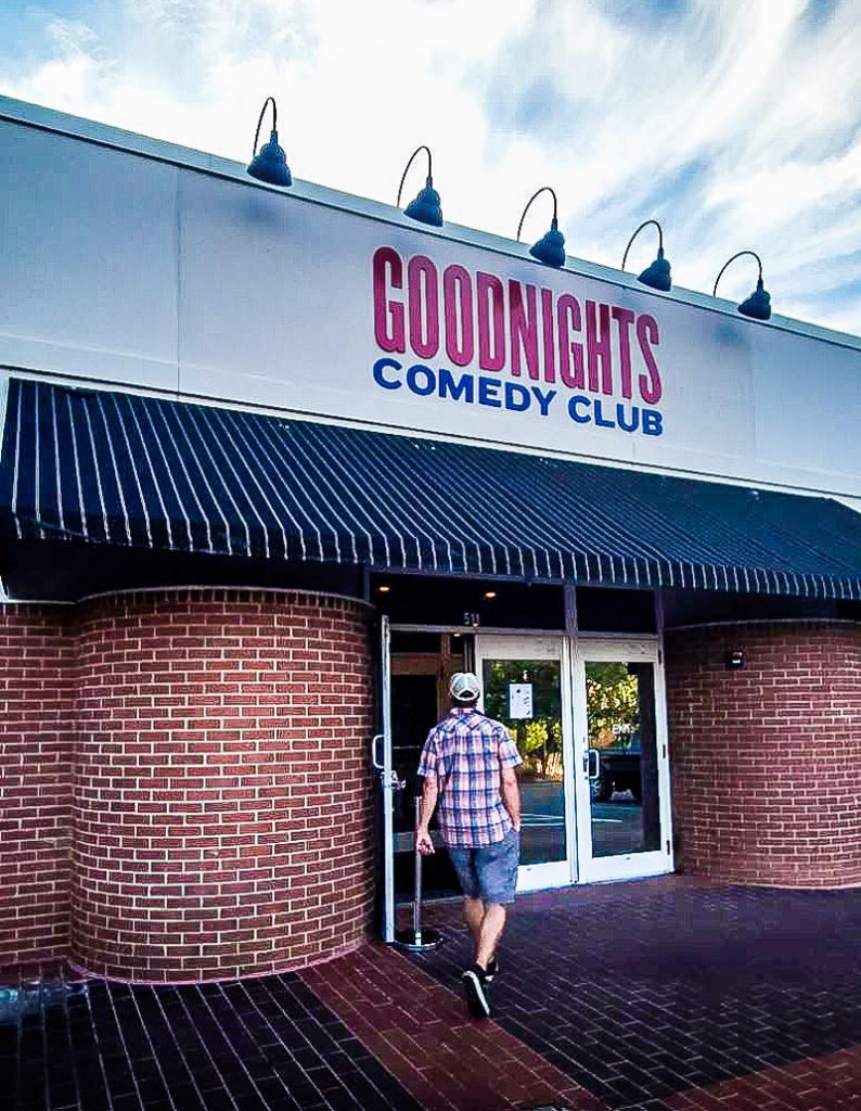 man walking into goodnights comedy club in the village district raleigh