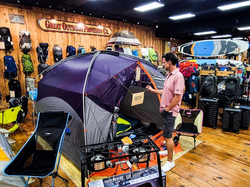 Man looking at a tent inside a store