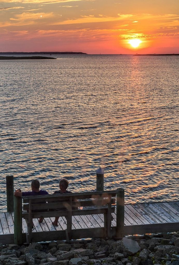 Couple watching a sunset over the water - Outer Banks