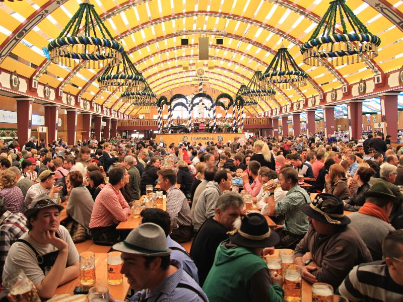 Large group of people drinking beer together at Oktoberfest festival