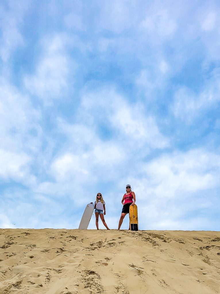 Mother and daughter standing on top of a sand dune - Outer Banks