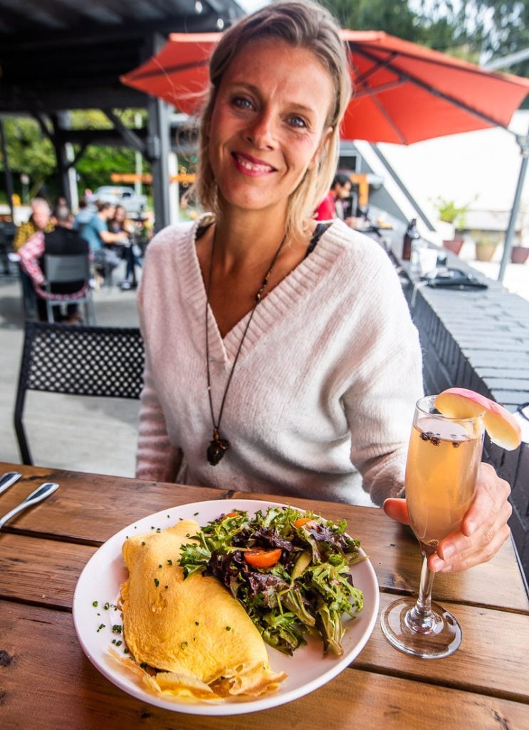 Lady enjoyng an omelette and glass of champagne for brunch at Wye Hill Kitchen