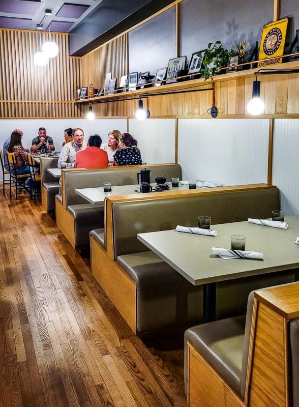 People dining in booths at a restaurant