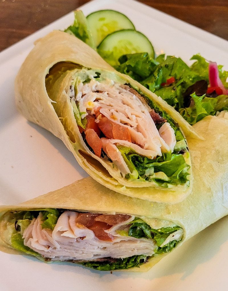 a wrap filled with tuna, lettuce and tomato