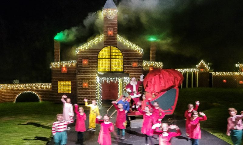santa and his helpers waving at the North Pole Village