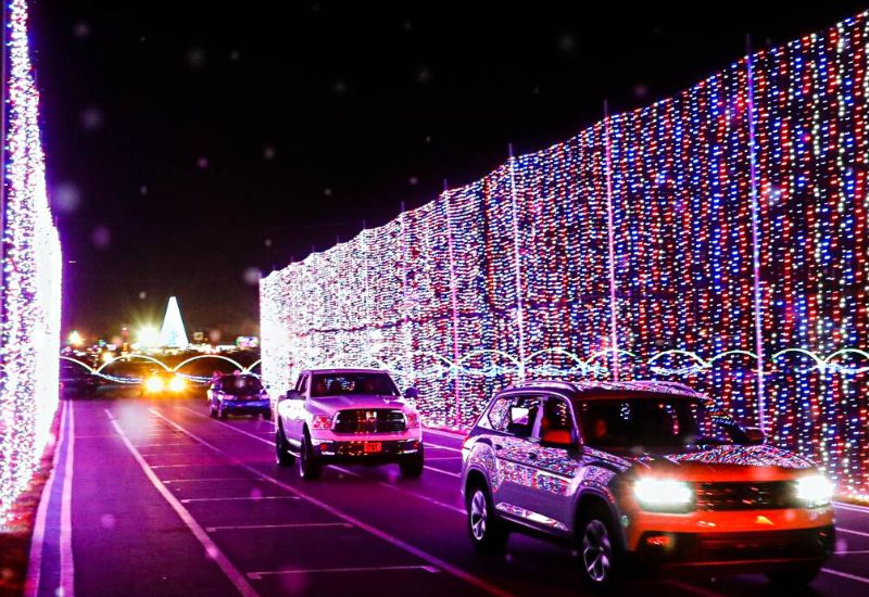 Cars driving through a wall of lights