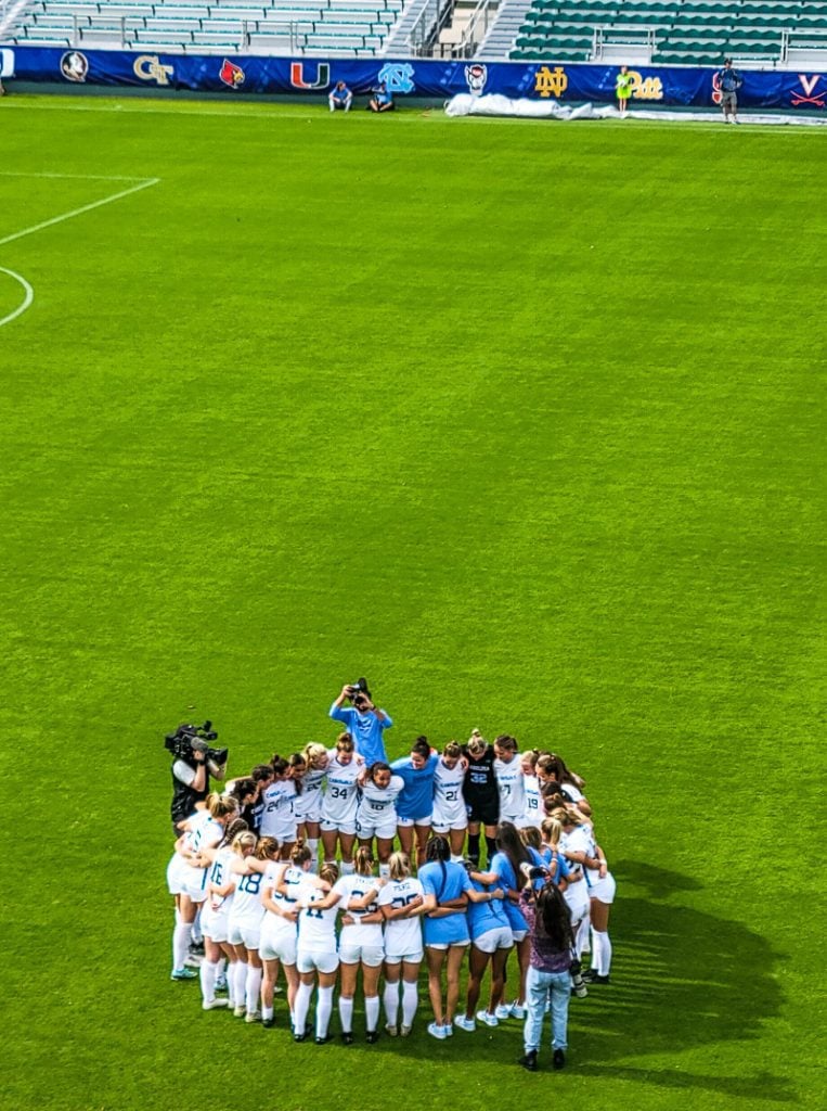 Ladies soccer team in a huddle before a game