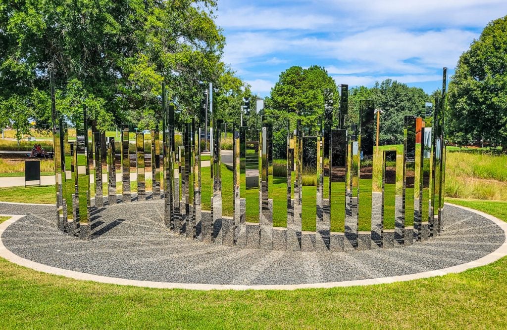 Art sculpture of vertical mirrors in a park