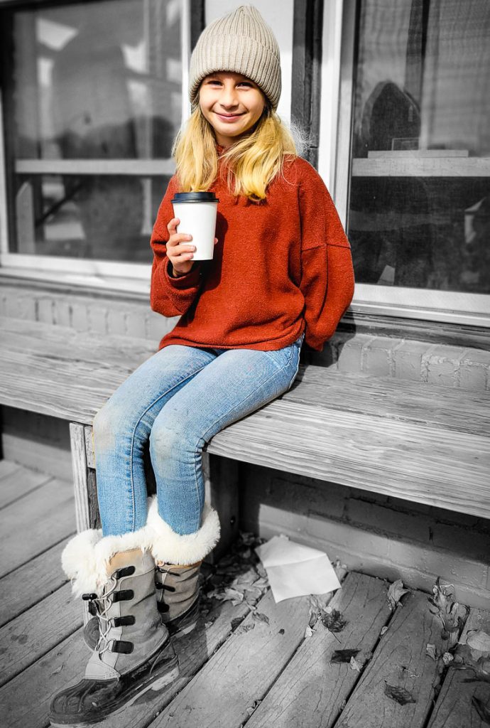 Girl enjoying a cup of hot chocolate.