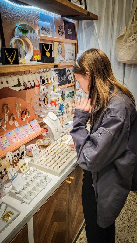 girl looking at jewelry on shelf