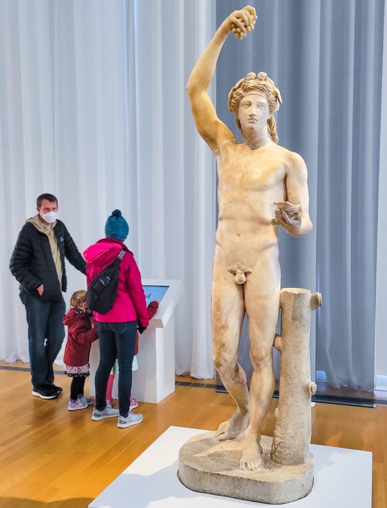Statue of a Greek on display in an art museum