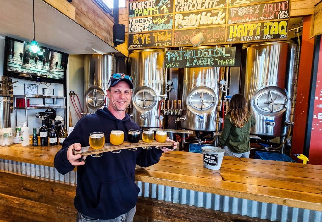 Man holding a flight of 5 beers