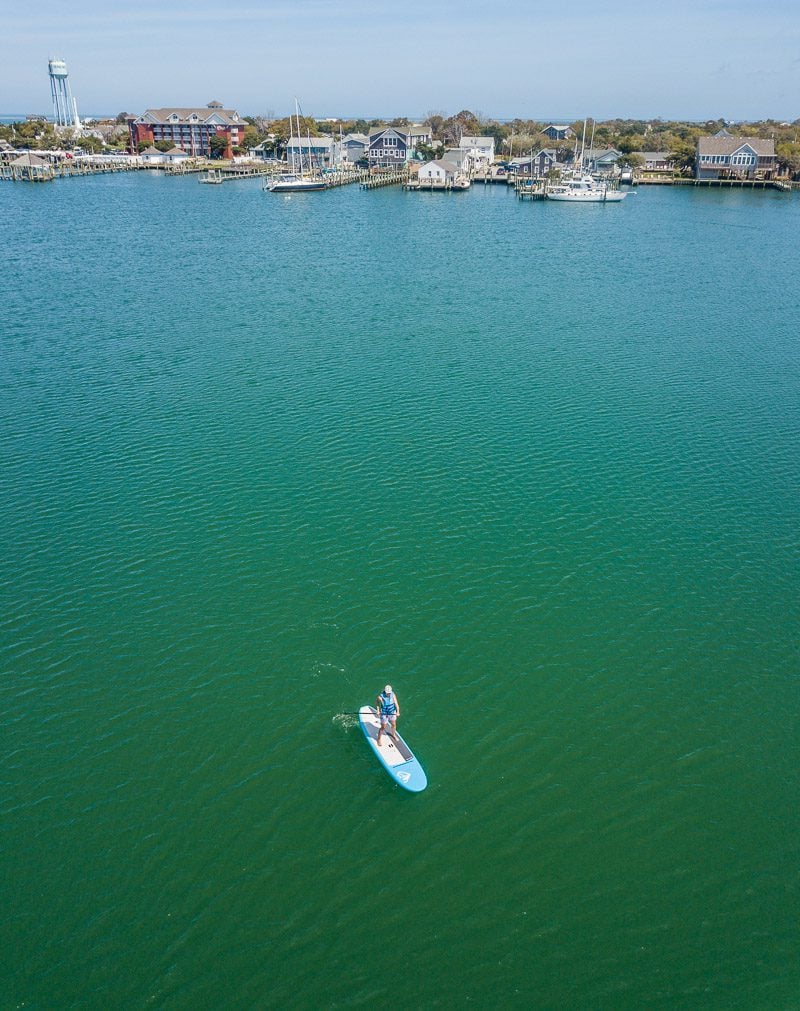 Paddle boarder in a harbor waterfront