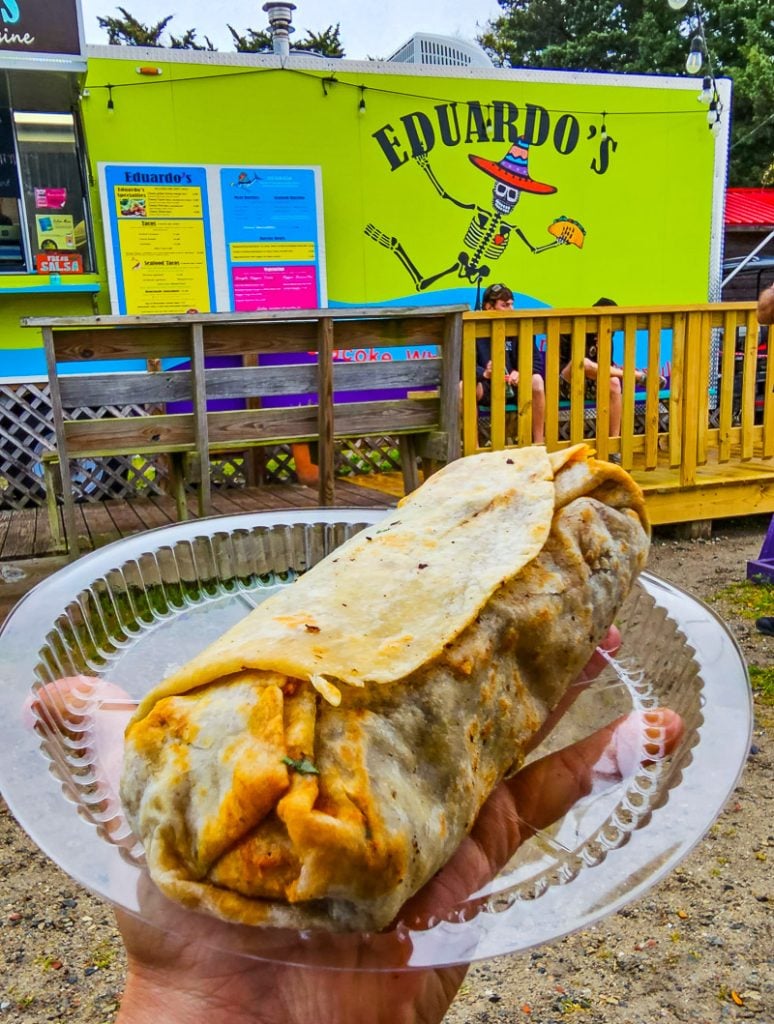 Burrito on a plate with a sign saying Eduardo's
