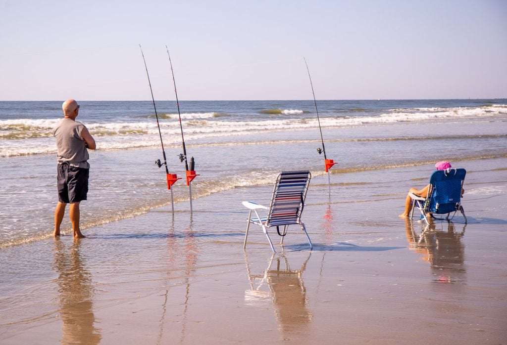 Man and lady beach fishing