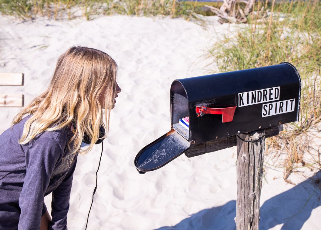 Girl looking inside a mailbox