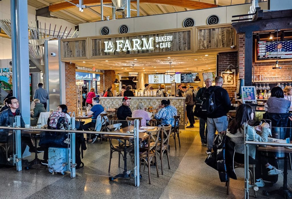 People sitting at a cafe inside an airport