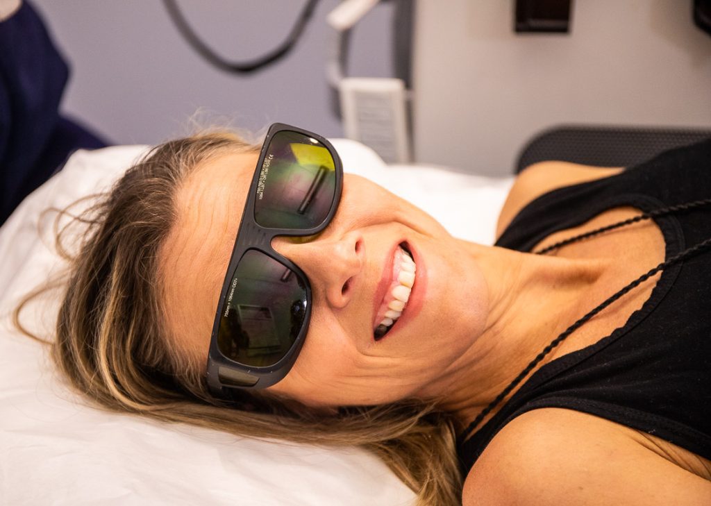 Lady with sunglasses on laying down