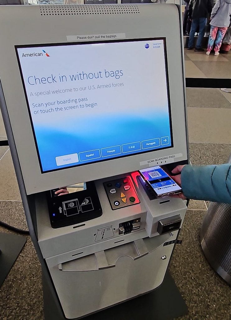 Person checking in at a kiosk at an airport
