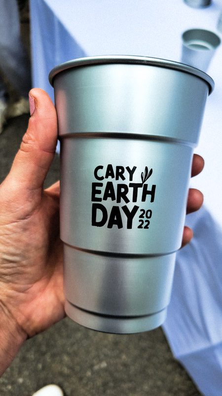 person holding earth day cup